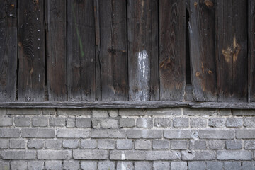 Old dirty wall of boards and white bricks