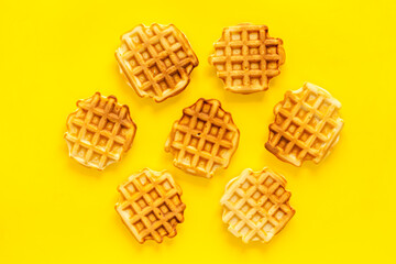 Traditional belgian waffles on yellow background top view mockup
