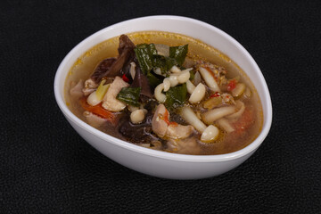Thai style soup with meat and mushrooms