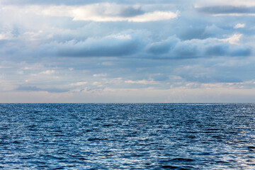 Obraz premium Beautiful cloudy evening on Baltic sea. Natural background. Latvia. Evening calm on the Sea. Copy space for text