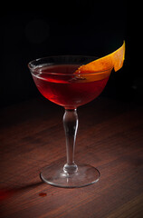 Negroni served up on a wood bartop