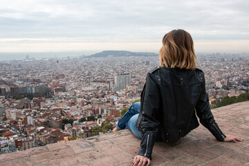 happy girl enjoys the views of a viewpoint in the city of Barcelona