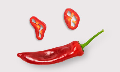 Red peppers and sliced peppers on a white background