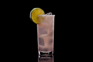 Paloma cocktail in a highball glass, black background