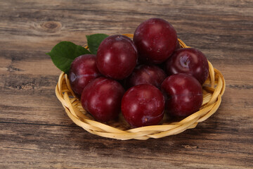 Plum heap in the wooden basket