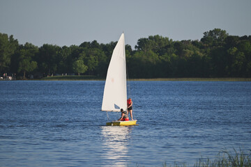 Two people sailing on the lake
