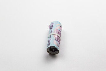 A roll of Ukrainian money. Banknotes of Ukraine against white background.Five thousand hryvnia with one thousand hryvnia five bills in the roll