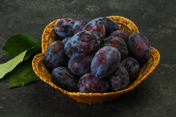 Ripe plum heap in the basket