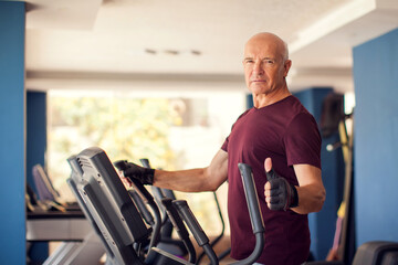 A portrait of senior man in the gym training in the cardio zone. People, health and lifestyle concept