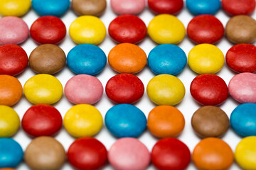 Close up of a pile of colorful chocolate coated candy, chocolate pattern, chocolate background