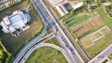 Aerial view of two lane bridge driveway. There is an inner ring road at the bottom.  Vehicles and commercial vehicles can also be seen. 