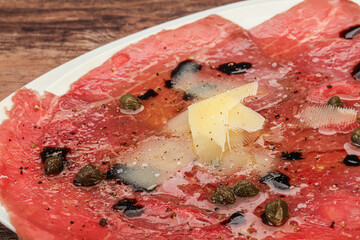 Carpaccio with capers, oil and parmesan