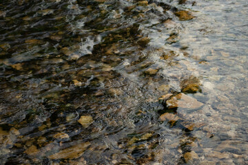 Transparent water with overflows in shallow water and small river stones - wallpaper