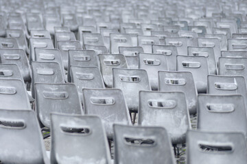 Empty plastic chairs outdoors on rainy day