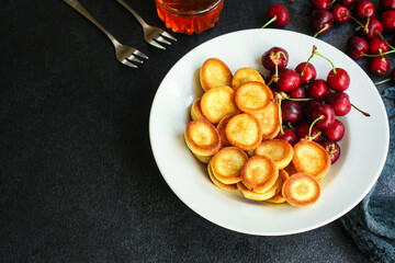 Mini pancakes cereal sweet breakfast snack dessert Menu serving. food background top view copy space