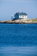 Fototapeta na wymiar A lighthouse on the rock, the Swedish west coast, Sweden