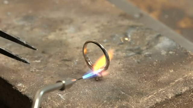 Craftsman diamond welding gold ring.Diamond ring jewelery product. Close up craftsman workshop macro shooting. hand made jewelery making. in jewelery master workshop solitaire rings
