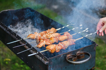 Pork skewers skewered on a skewer by hand and fried on the grill