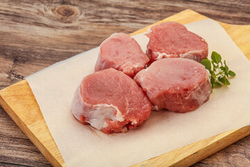 Raw pork medallion served rosemary