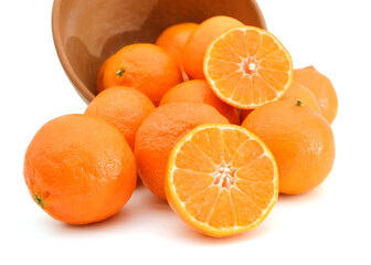 orange mandarines heap in wooden bowl on white