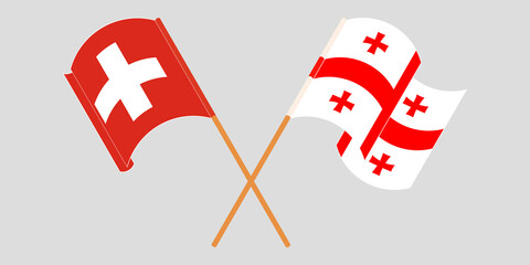 Crossed and waving flags of Georgia and Switzerland