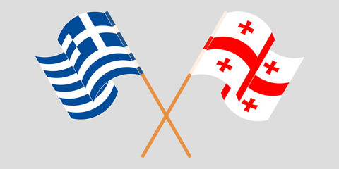 Crossed and waving flags of Georgia and Greece