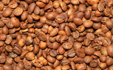 Brown roasted whole coffee beans background. Dark roast for your brewing method. Seed nature from above view. Group agriculture grain arabica. Photos from the top view.