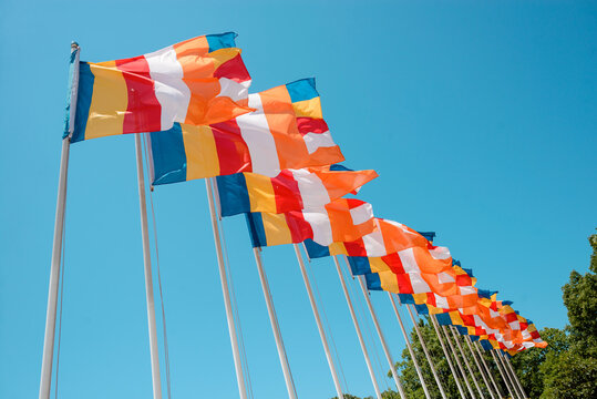 Row of Buddhist flags fluttering on blue sky