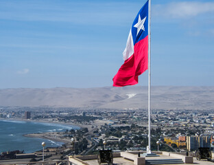 View of Arica city in the north of Chile with Chilean flag waving