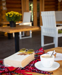 Coffee mug on the table. Autumn evening with coffee and fresh pastries. Cozy autumn evening.