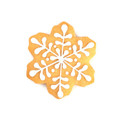 Christmas gingerbread covered with white icing in the shape of a snowflake, isolated on a white background