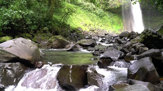 La Fortuna Waterfall in the rainforest near Arenal Volcano in Costa Rica, Central America. Beautiful nature landscape at toursit travel destination landmark.