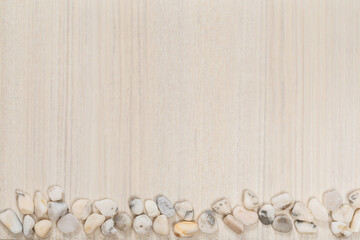 Fototapeta na wymiar White mooth sea stones on white wooden surface. Copy space. Space for text. Ash wood background.