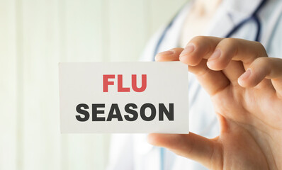 Flu Season card in hands of Medical Doctor