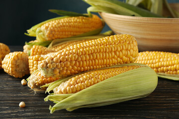 Composition with fresh raw corn on wooden table