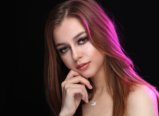 Fototapeta premium Girl on a dark background with purple backlight