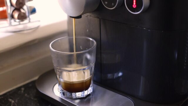 Espresso coffee being made with a nespresso machine