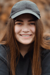 Beautiful girl wearing casual t-shirt over brown background looking straight with smile on face. Laughing confident