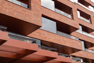 Texture view of beautiful red bricks modern building with large windows. New district architecture close-up in Oslo, Norway