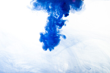 A cloud of blue paint released into clear water. Isolate on a white background.