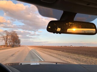 Fototapeta na wymiar Driving with Sunset Behind