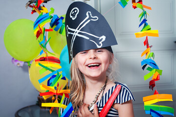 Cheerful little child in a pirate costume plays at home. Close-up. Children's birthday party. Fun...