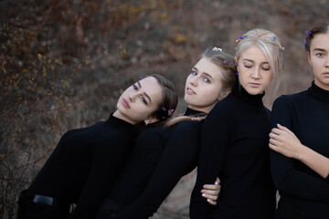 Beautiful girls in black clothes with flowers in their hair, a lot of girls, body positivity