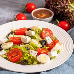 Colorful vegetables with quail eggs and cheese on a plate. Healthy and diet food concept.