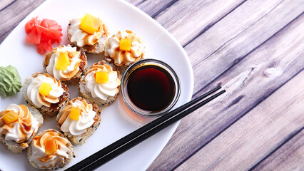 Sushi  on a white plate and wooden texture