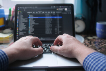 image of male hands on laptop keyboard