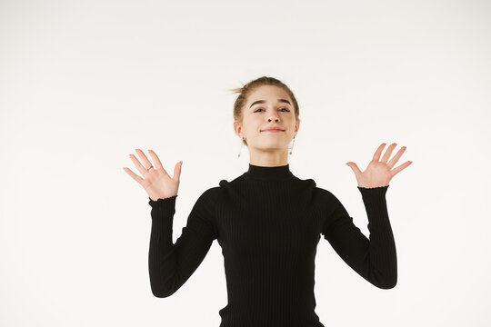 The girl in black clothes on a white background depicts the emotion.
