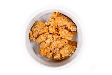 Digestible light food for dogs with digestive health problems consisiting of bowl with cooked chicken meat, rice and mashed carrots on white background