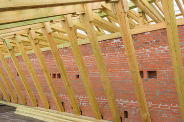 Rafter system of a wooden roof. Wooden construction. The construction of the roof of a residential building.