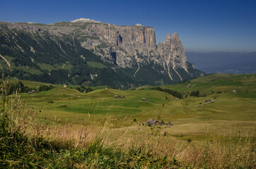 Fototapeta na wymiar Sciliar mountain with Santner peak at its north west end as seen in the morning from Alpe di Siusi/Seiser Alm high plateau, on the trail over Denti di Terrarossa range, Dolomites, South Tirol, Italy.